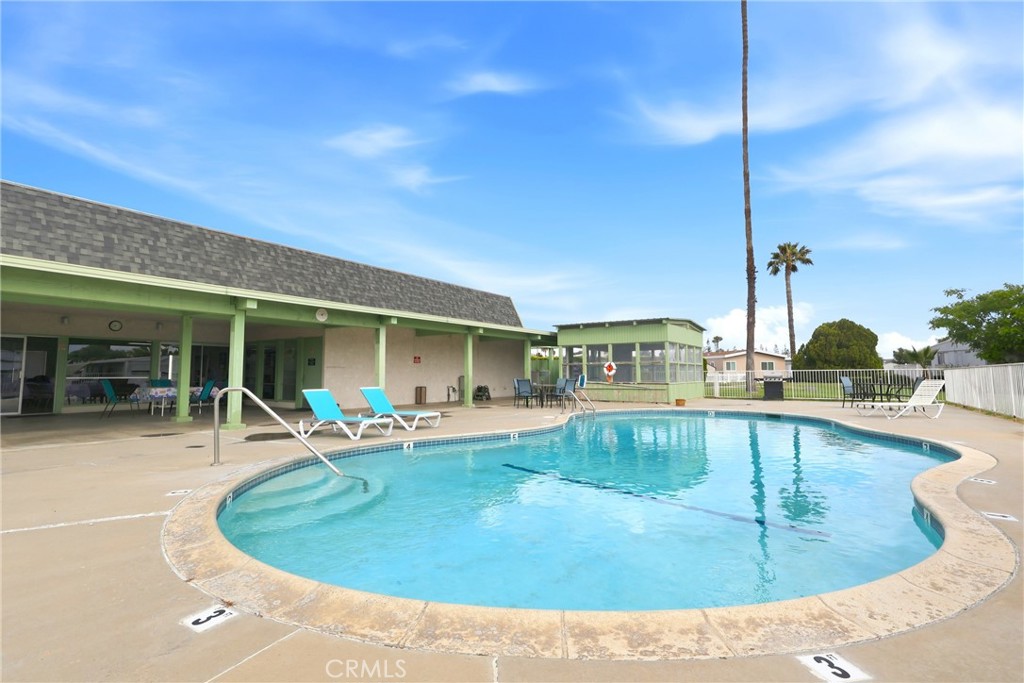 9391 California Avenue, Unit 35 Riverside, CA 92503 - Photo 29 of 32 a view of a swimming pool with chairs