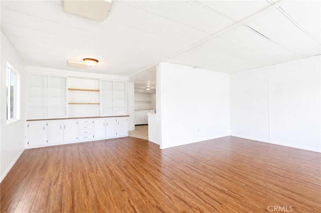9391 California Avenue, Unit 35 Riverside, CA 92503 - Photo 5 of 32 an empty room with wooden floor and windows