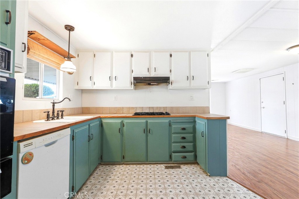 9391 California Avenue, Unit 35 Riverside, CA 92503 - Photo 10 of 32 a kitchen with a sink window and cabinets