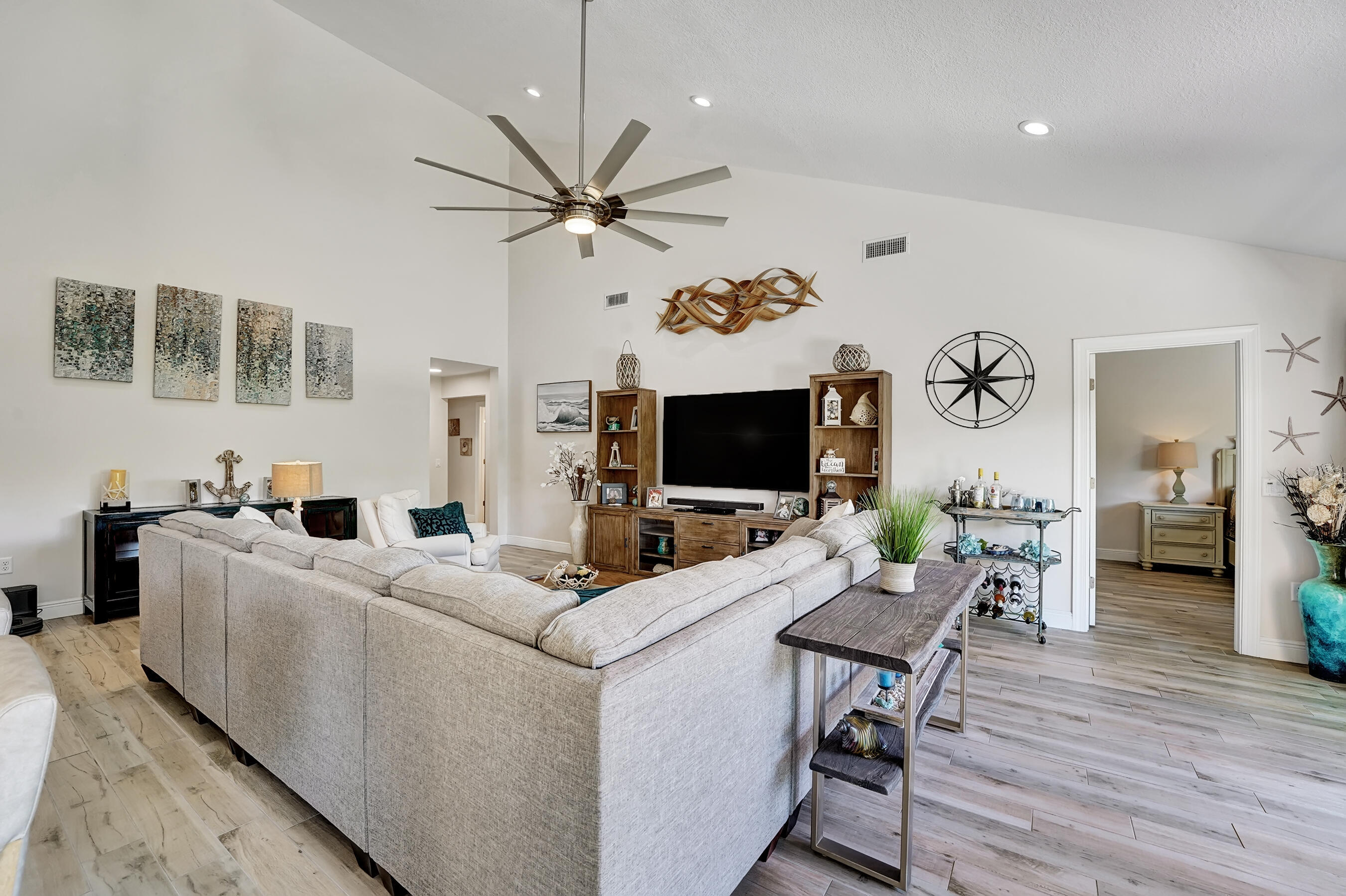 118 Ridge Road Jupiter, FL 33477 - Photo 12 of 27 a living room with furniture a flat screen tv and a table