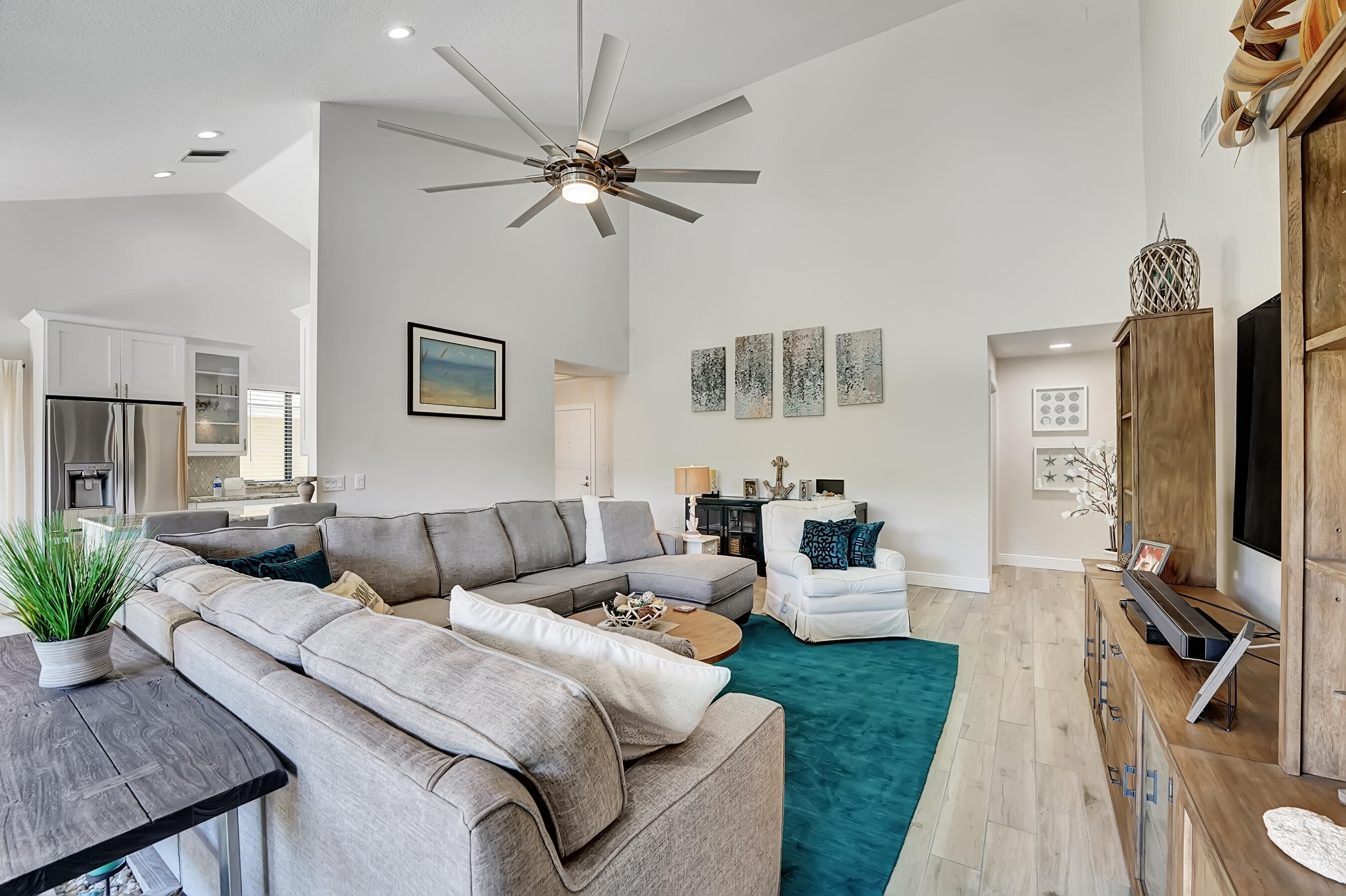118 Ridge Road Jupiter, FL 33477 - Photo 13 of 27 a living room with furniture a ceiling fan and a flat screen tv