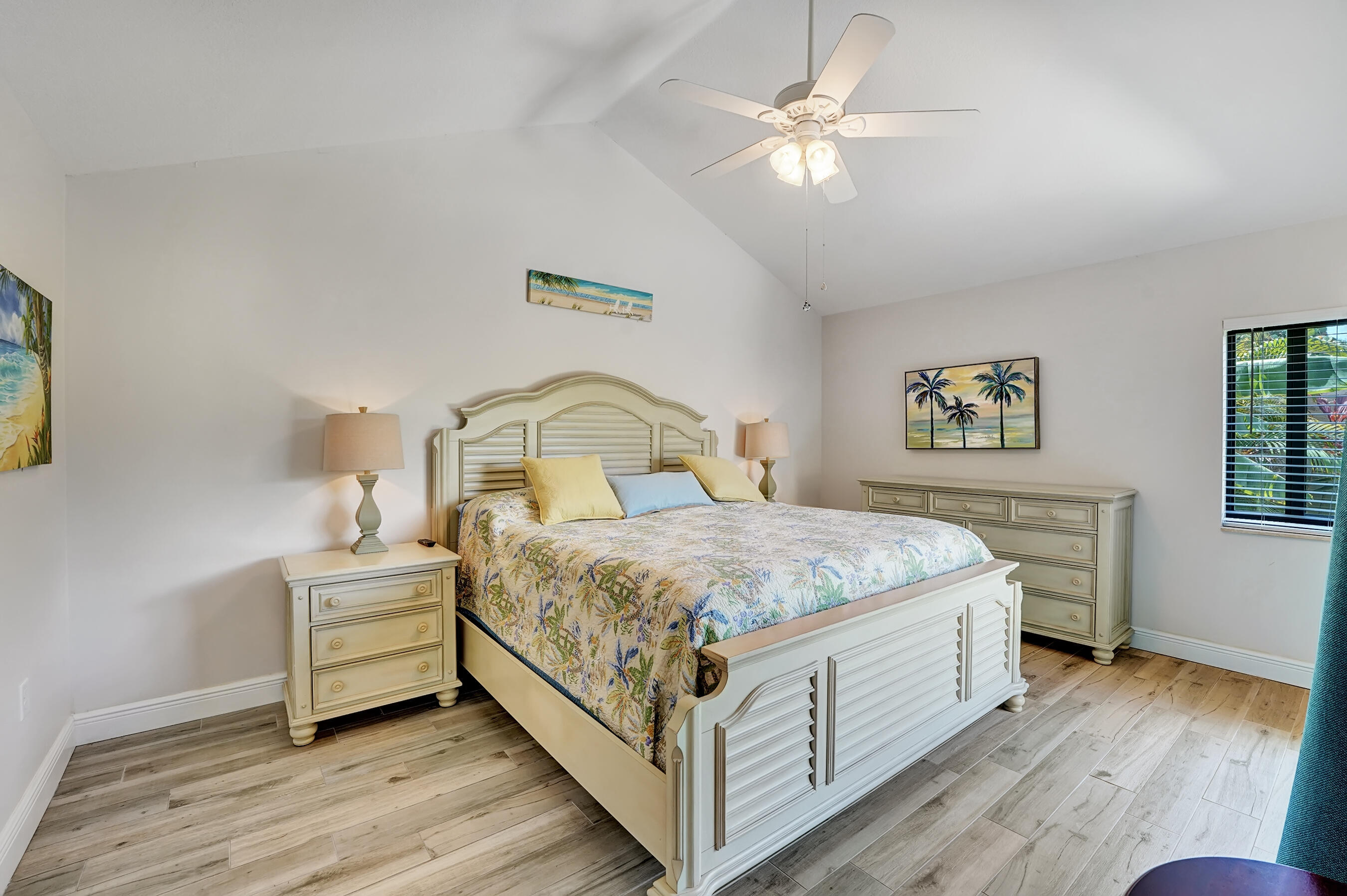 118 Ridge Road Jupiter, FL 33477 - Photo 15 of 27 a bedroom with a bed and a chandelier