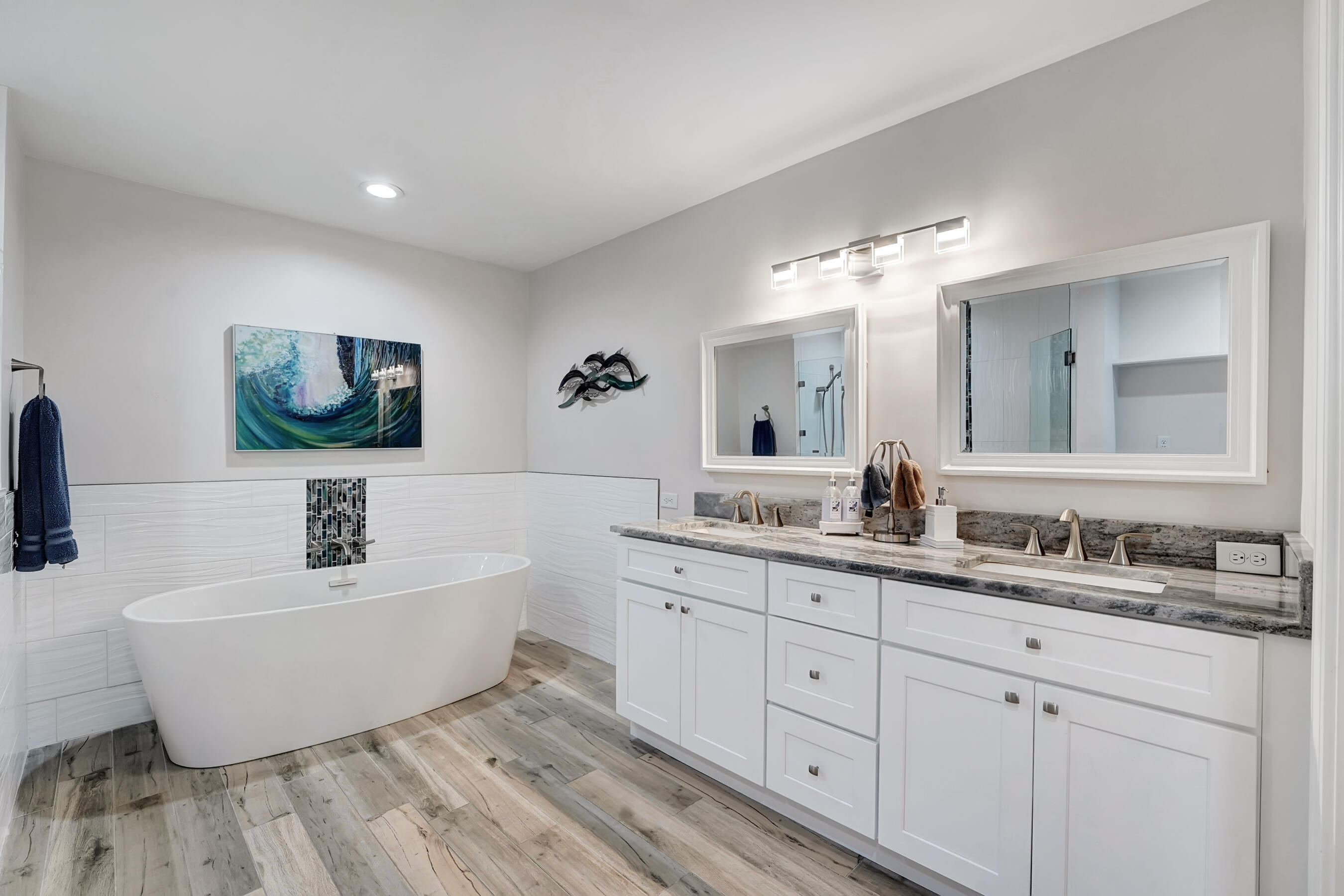 118 Ridge Road Jupiter, FL 33477 - Photo 18 of 27 a spacious bathroom with a double vanity sink mirror and bathtub