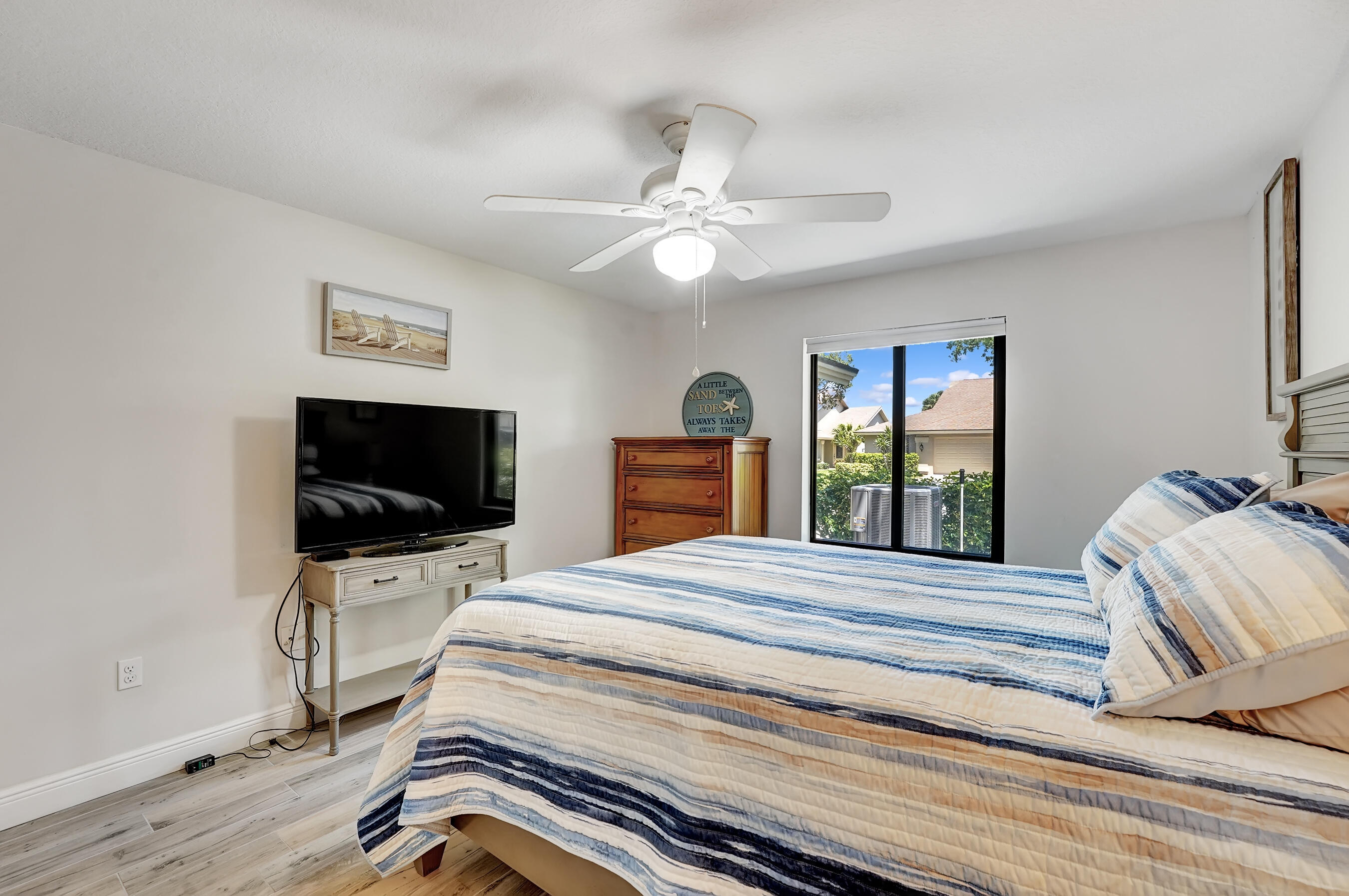 118 Ridge Road Jupiter, FL 33477 - Photo 22 of 27 a bedroom with a bed and a flat screen tv
