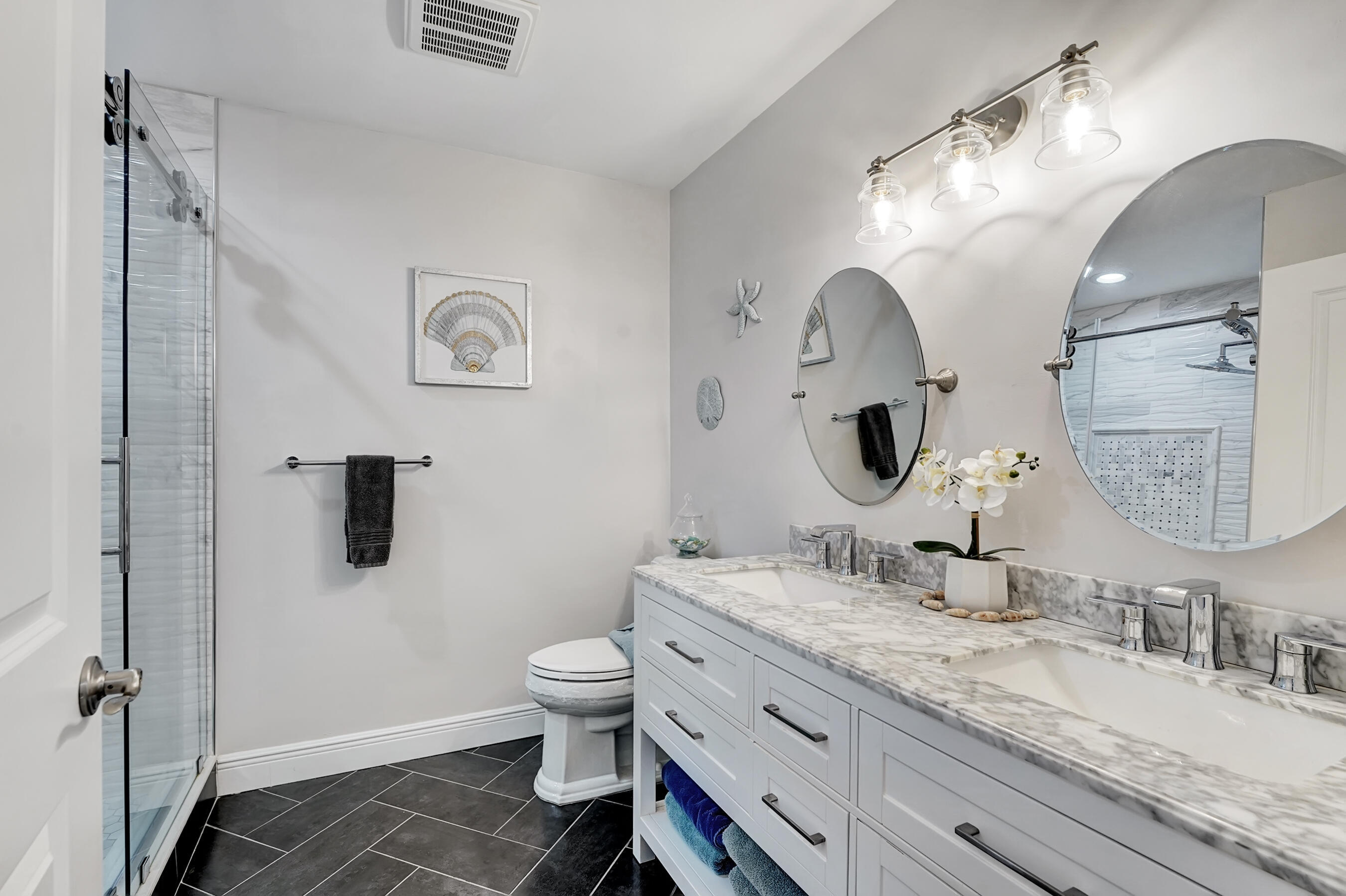 118 Ridge Road Jupiter, FL 33477 - Photo 23 of 27 a bathroom with a granite countertop toilet sink and mirror
