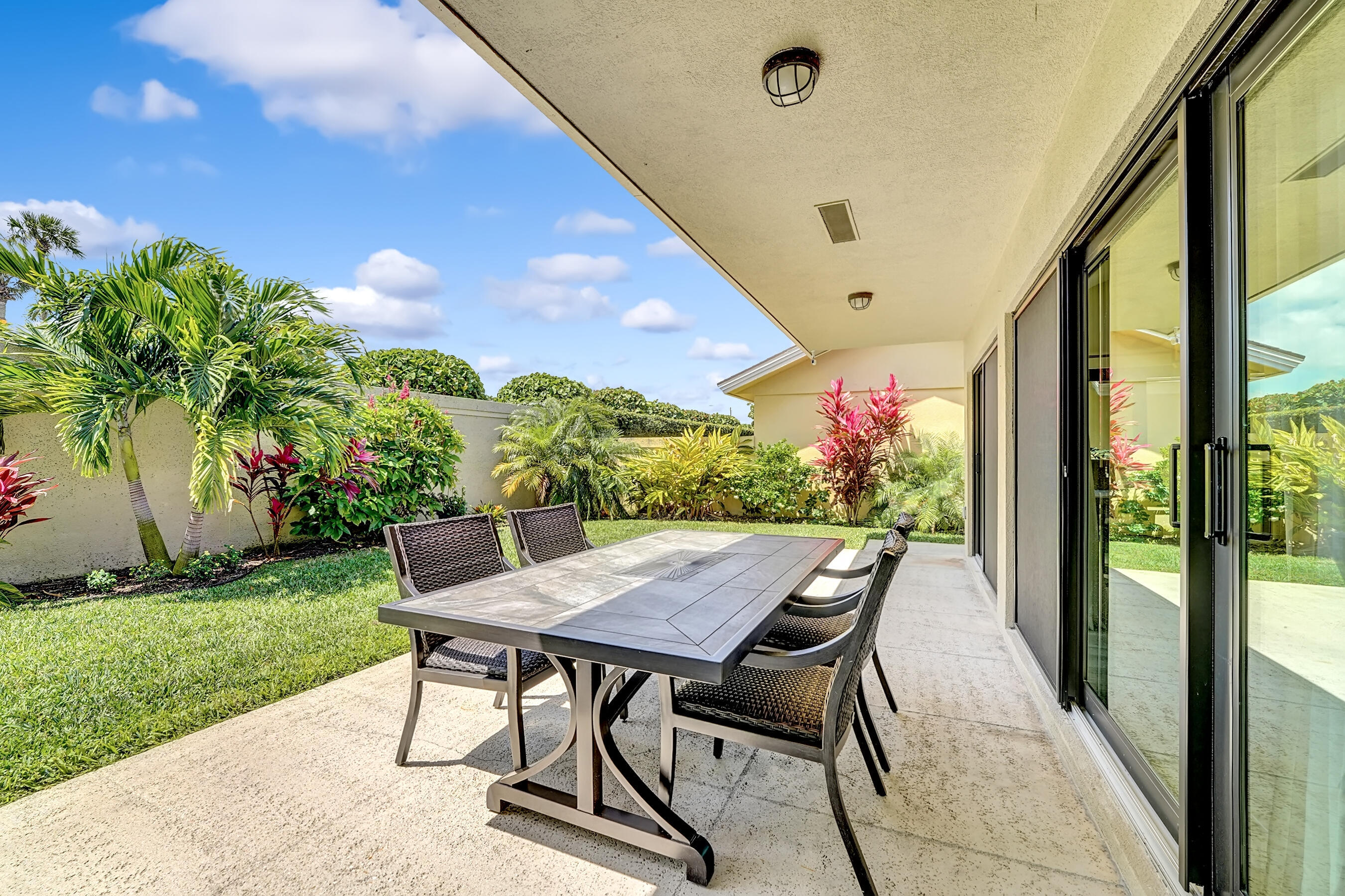 118 Ridge Road Jupiter, FL 33477 - Photo 25 of 27 a view of an outdoor dining space with a table and chairs