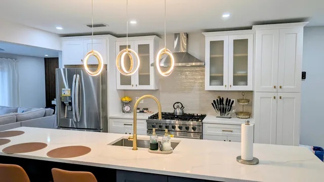 a kitchen with stainless steel appliances kitchen island granite countertop a sink and cabinets