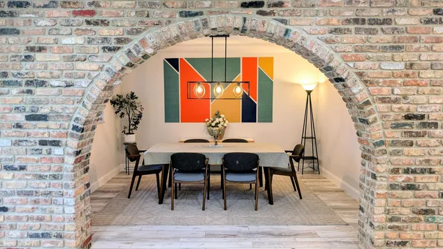 a dining room with furniture and wooden floor