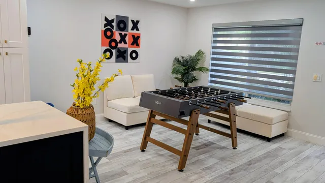 a living room with furniture and wooden floor