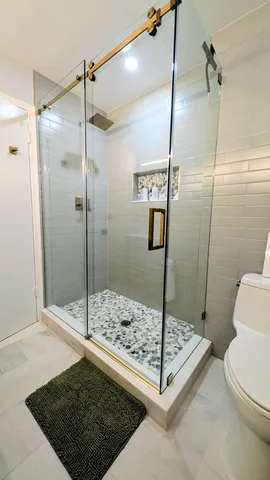 a bathroom with a shower and toilet