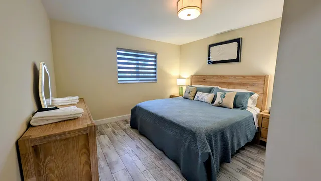 a bedroom with a bed and wooden floor