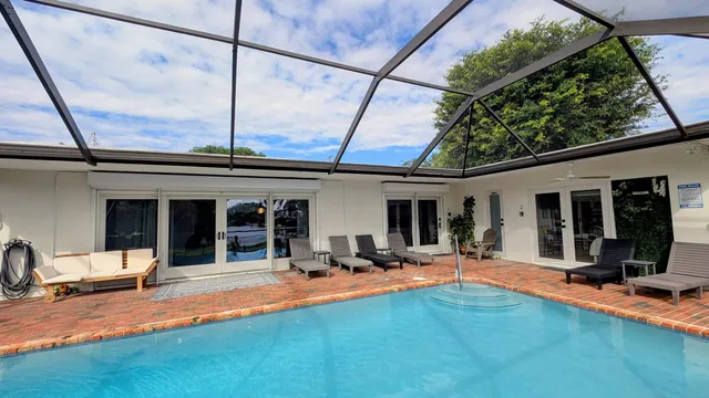a view of a backyard with furniture and a table and chairs