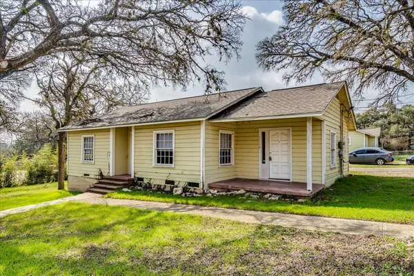 a front view of house with yard outdoor seating and barbeque oven