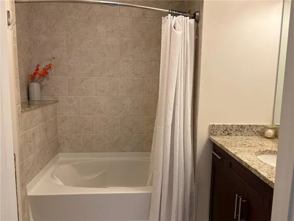 a bathroom with a tub and a shower