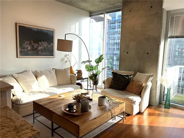 a living room with furniture and wooden floor