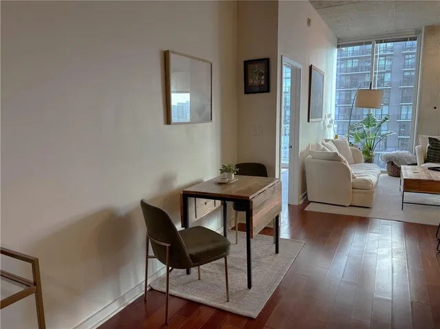 a bathroom with a granite countertop sink a toilet and a large mirror