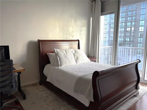 a bed sitting in a bedroom next to a window