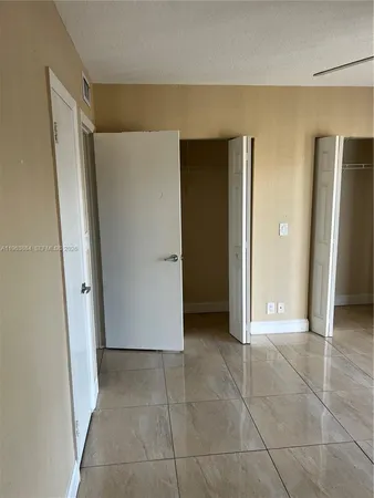 an empty room with windows and entrance