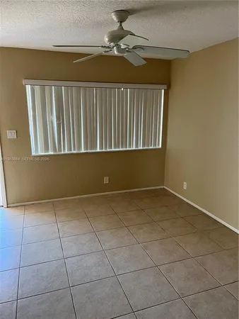 a view of a livingroom with an empty space and a window