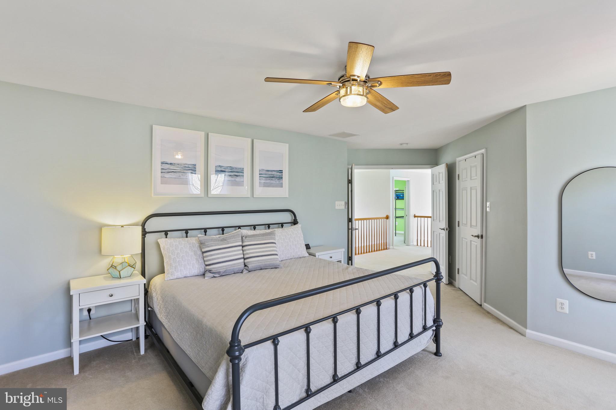 5810 Artisan Drive Eldersburg, MD 21784 - Photo 16 of 39 a bedroom with a bed and a chandelier