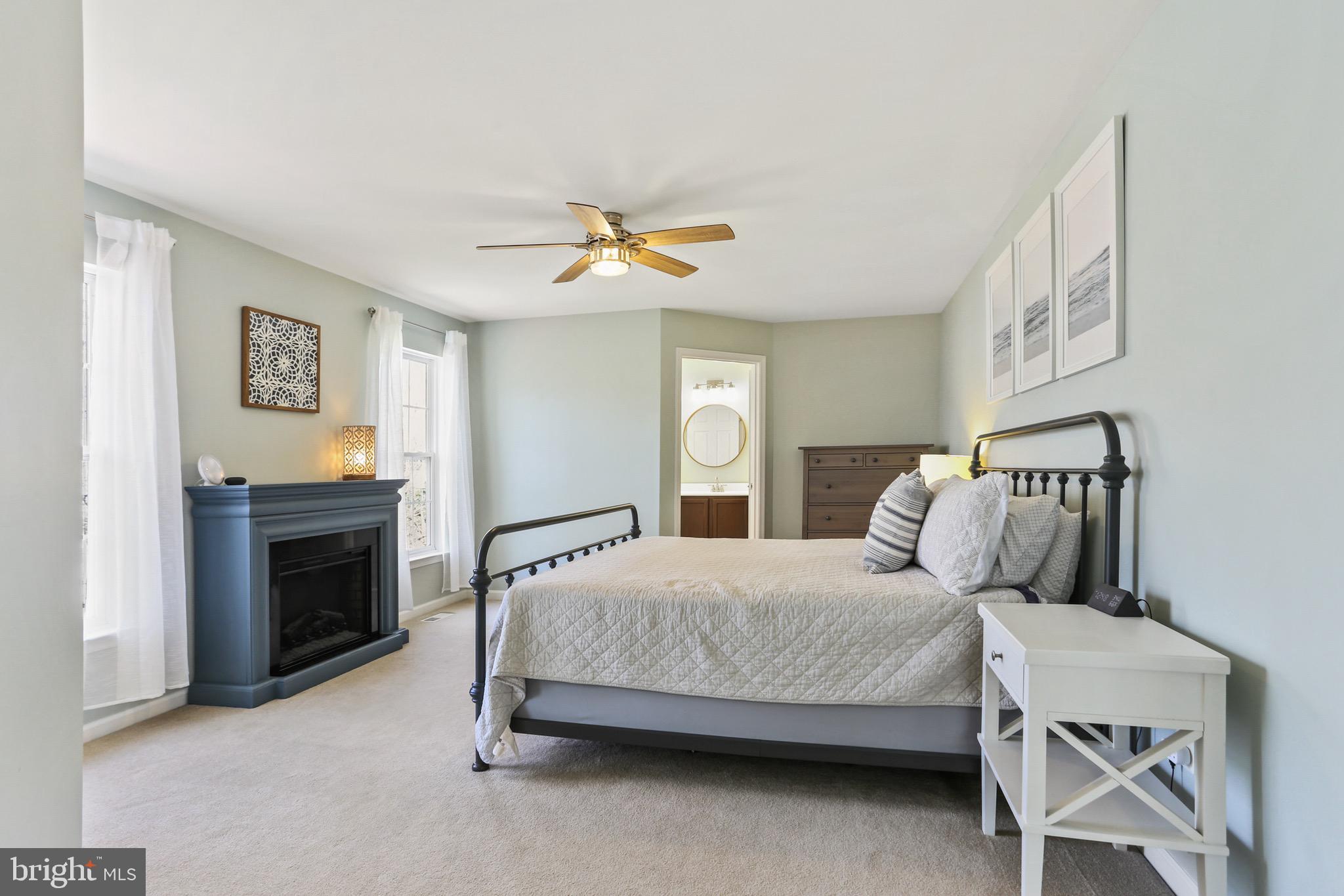 5810 Artisan Drive Eldersburg, MD 21784 - Photo 18 of 39 a bedroom with a bed and a chandelier