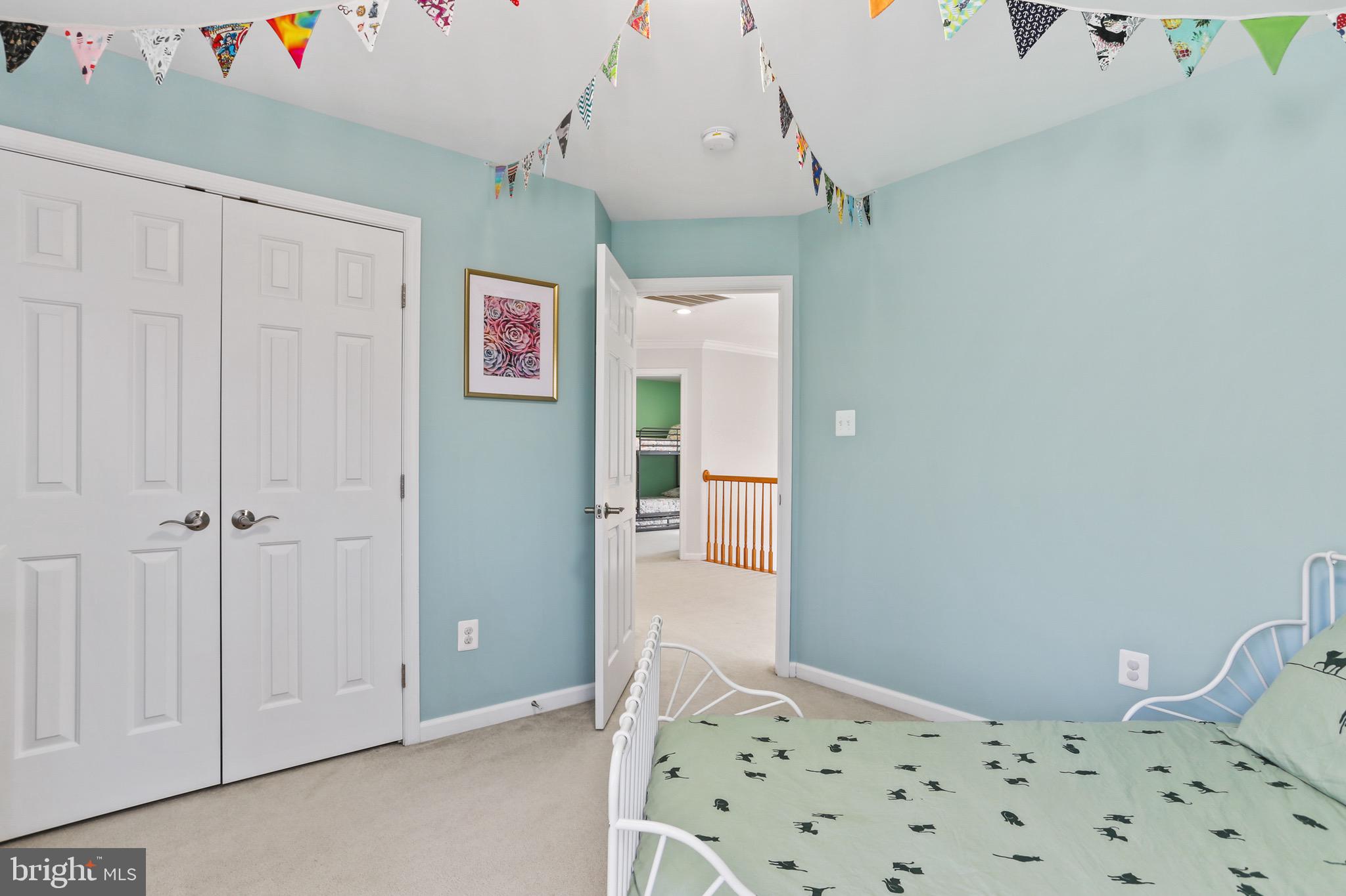 5810 Artisan Drive Eldersburg, MD 21784 - Photo 22 of 39 a bedroom with a bed and a chandelier