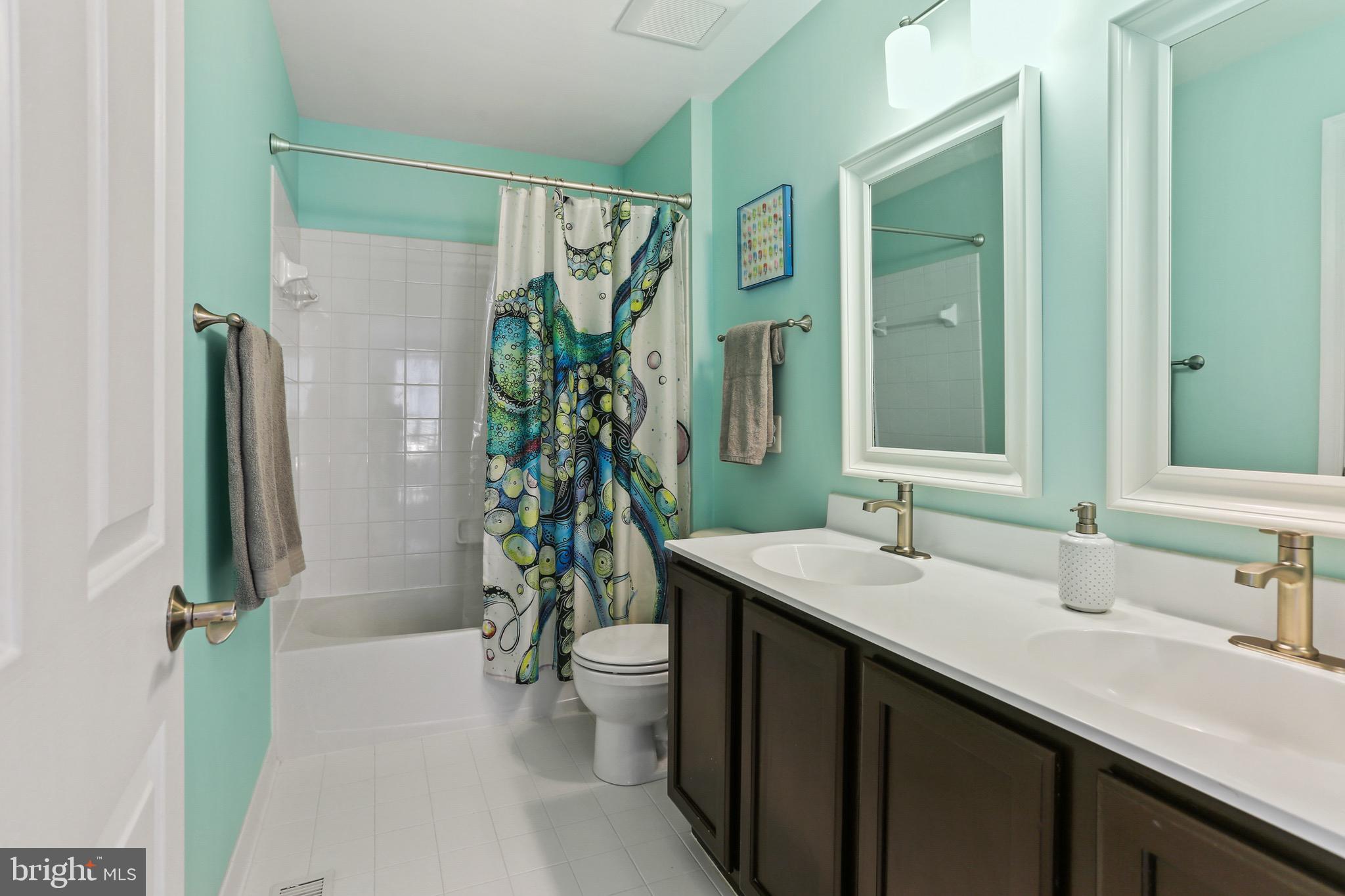 5810 Artisan Drive Eldersburg, MD 21784 - Photo 26 of 39 a bathroom with a granite countertop sink a toilet and a mirror