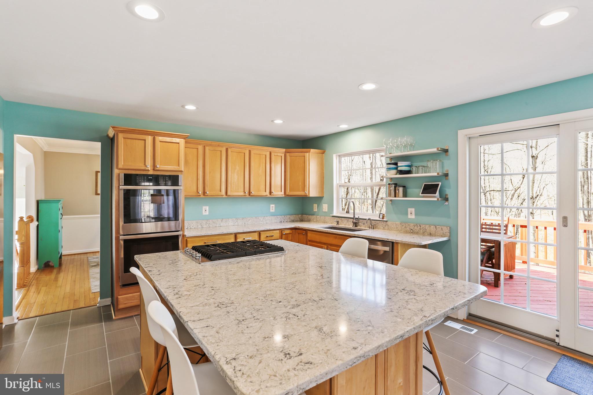 5810 Artisan Drive Eldersburg, MD 21784 - Photo 4 of 39 a kitchen with stainless steel appliances granite countertop a sink a stove and a refrigerator