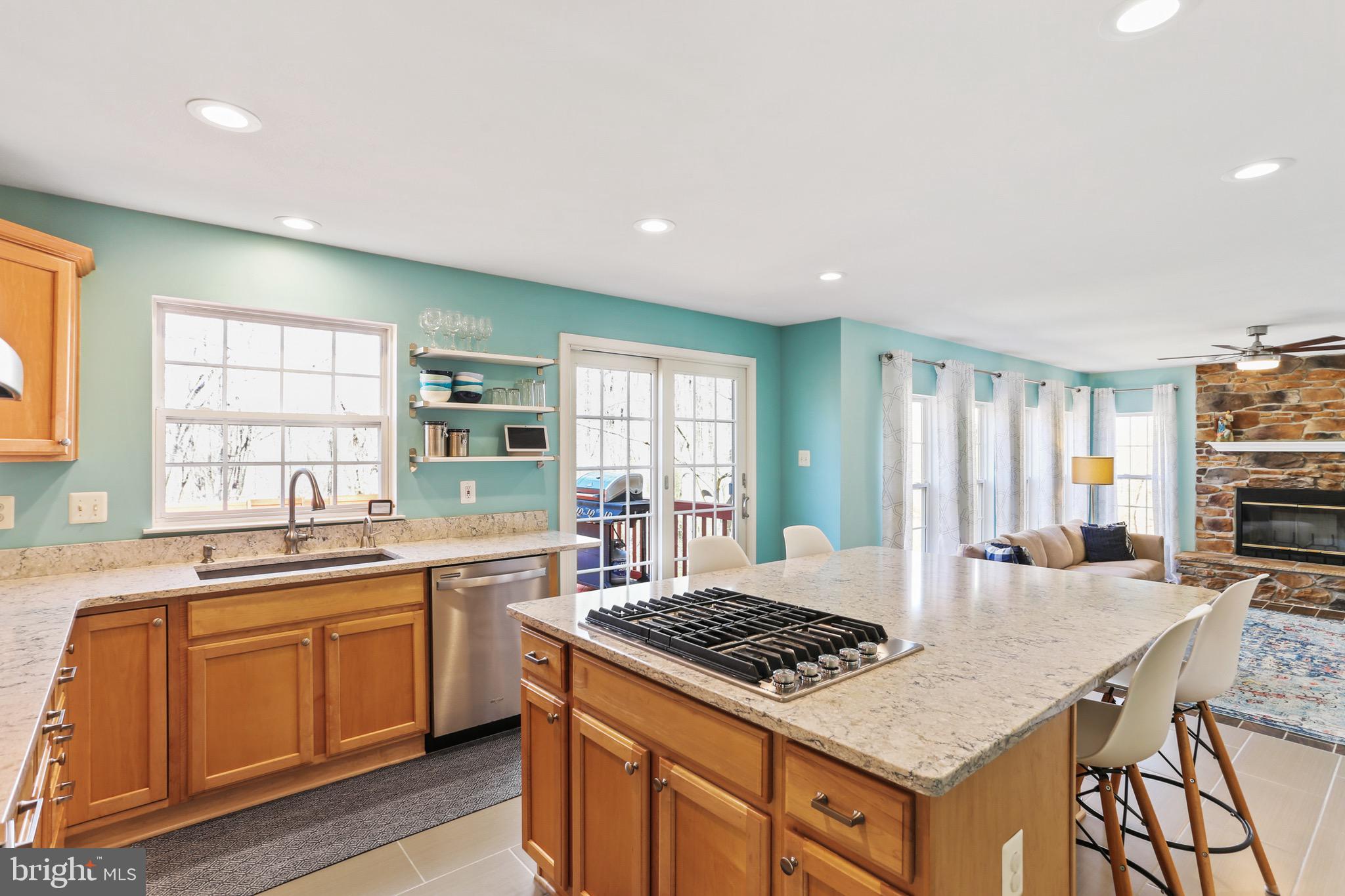 5810 Artisan Drive Eldersburg, MD 21784 - Photo 6 of 39 a kitchen with a stove a sink a dining table and chairs