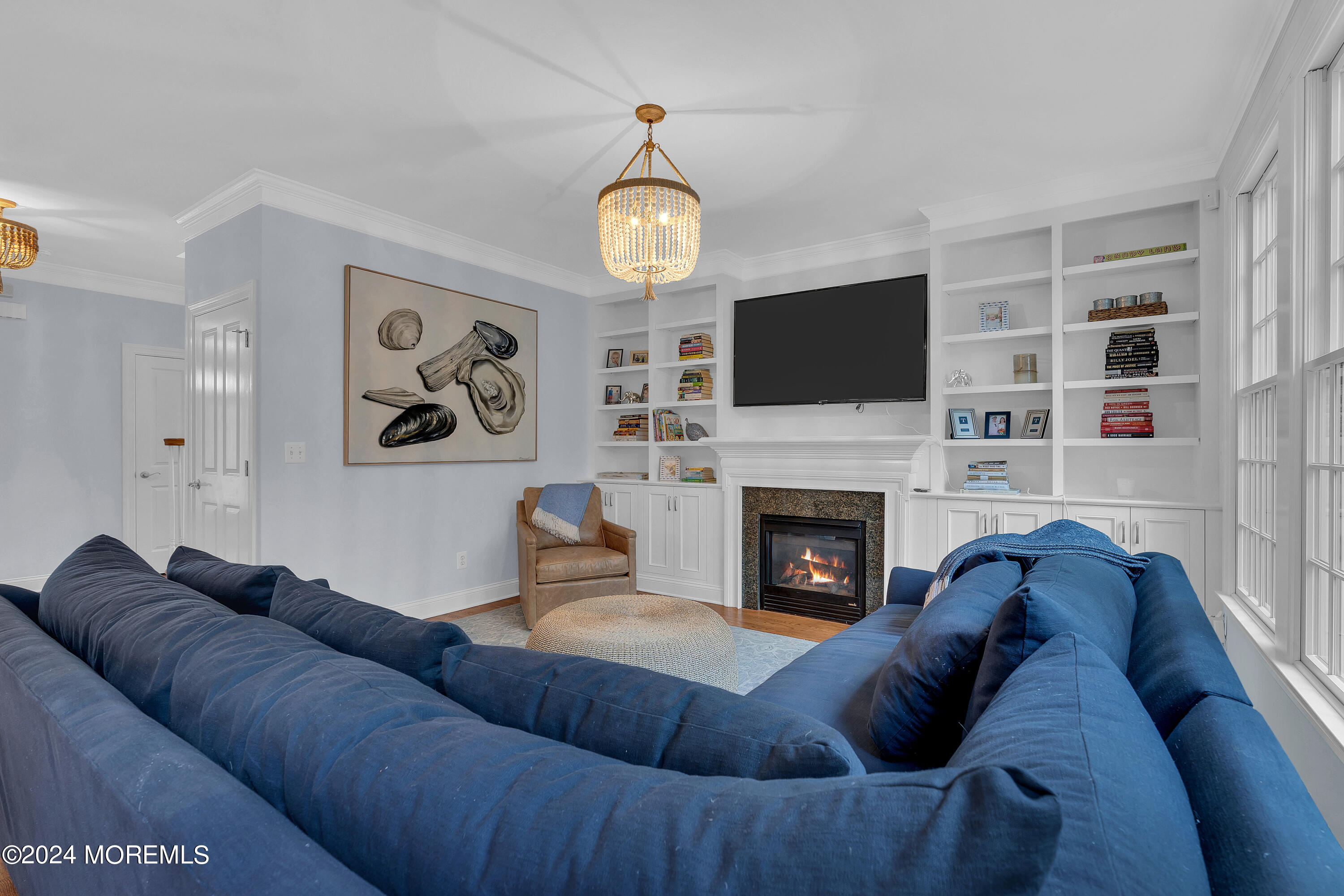 314 Jersey Avenue Spring Lake, NJ 07762 - Photo 13 of 33 a living room with furniture a fireplace and a flat screen tv