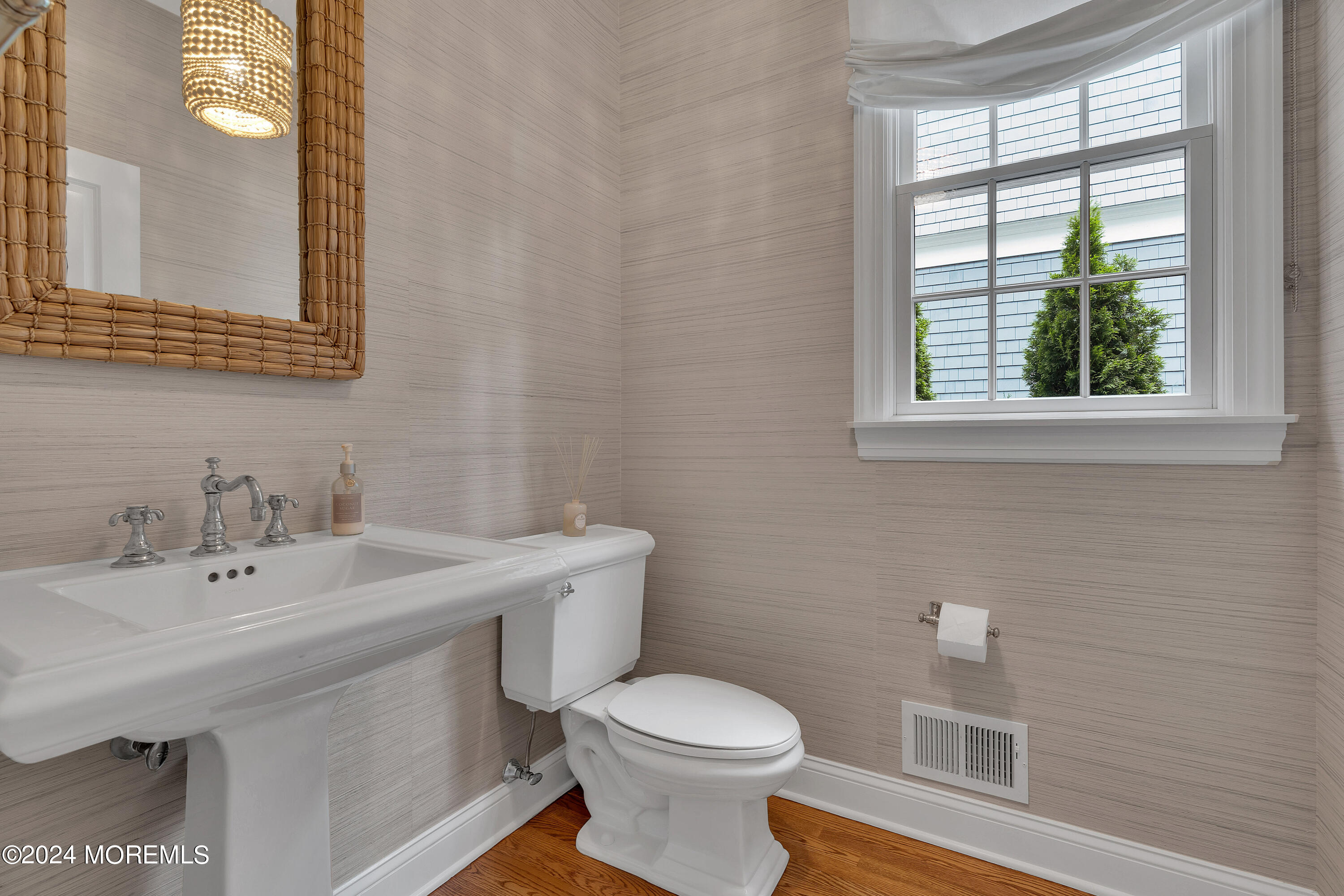 314 Jersey Avenue Spring Lake, NJ 07762 - Photo 14 of 33 a bathroom with a sink a toilet and a mirror