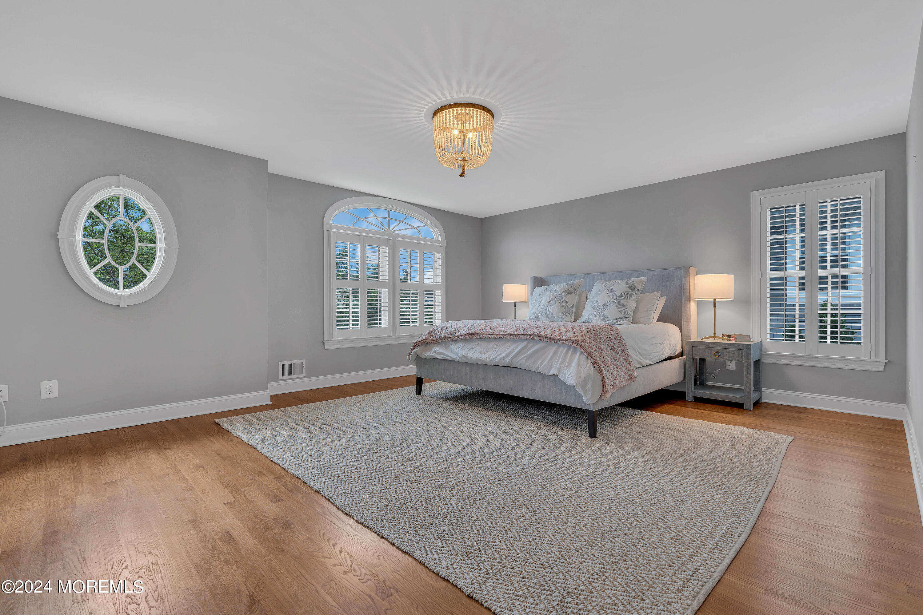 314 Jersey Avenue Spring Lake, NJ 07762 - Photo 16 of 33 a spacious bedroom with a bed a table and a window