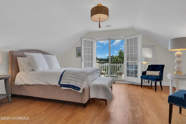 a bedroom with furniture and a large window