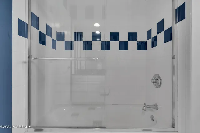 a bathroom with a glass door shower