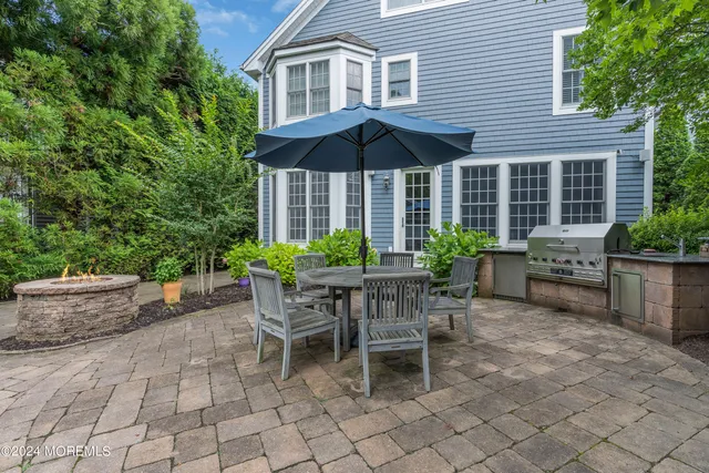 a patio with a table and chairs under an umbrella