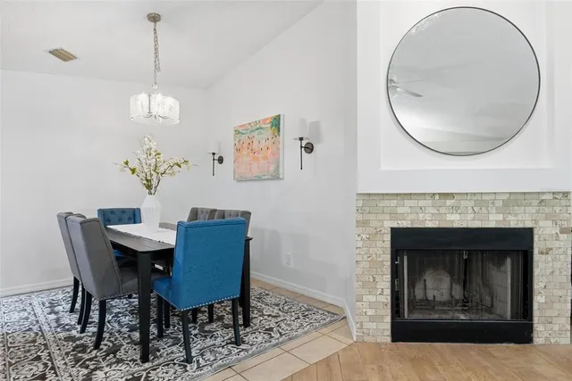 a kitchen with stainless steel appliances granite countertop a stove top oven a sink dishwasher and white cabinets with wooden floor