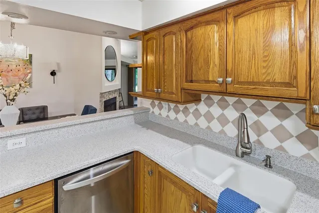 a kitchen with granite countertop a stove top oven microwave and cabinets