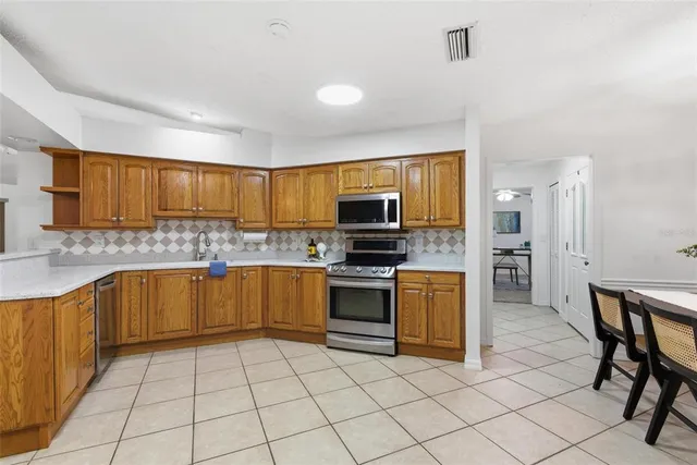 a bedroom with a bed a lamp and a chandelier