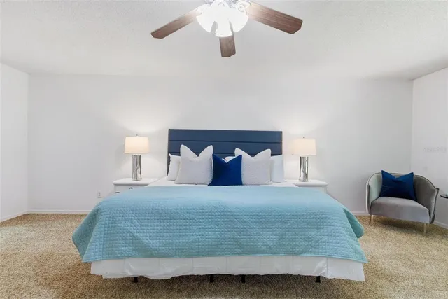 a bedroom with a bed a table and chair