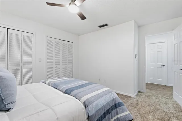 a bedroom with a bed and a night stand