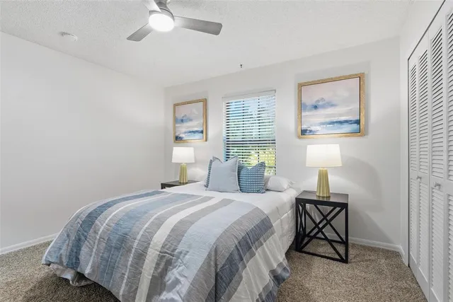 a bedroom with a bed and a painting on the wall