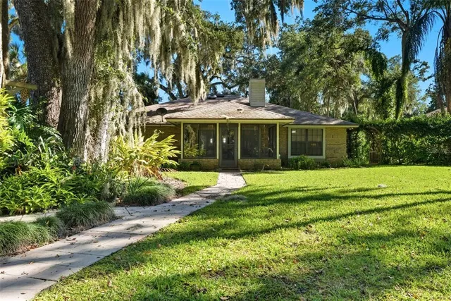 an aerial view of a house with swimming pool and garden