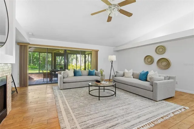 a view of a dining room with furniture large windows and wooden floor