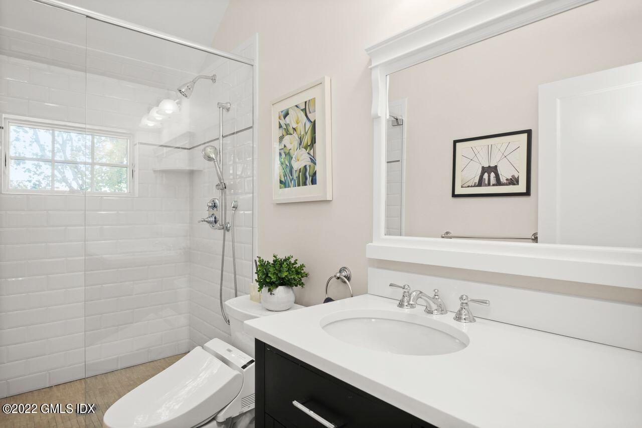 6 Ernel Drive Riverside, CT 06878 - Photo 17 of 26 a bathroom with a granite countertop sink a toilet and shower