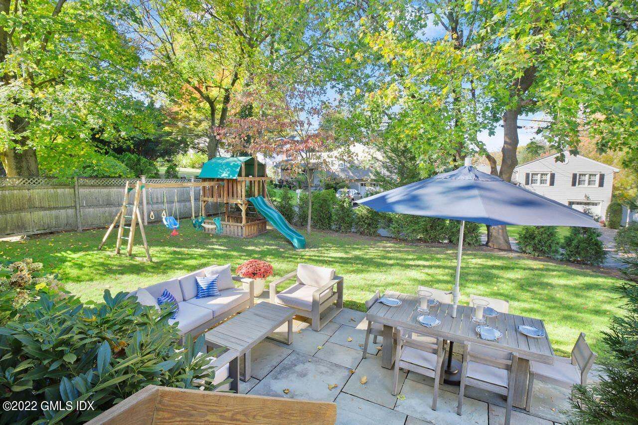 6 Ernel Drive Riverside, CT 06878 - Photo 21 of 26 a view of a chair and table under an umbrella