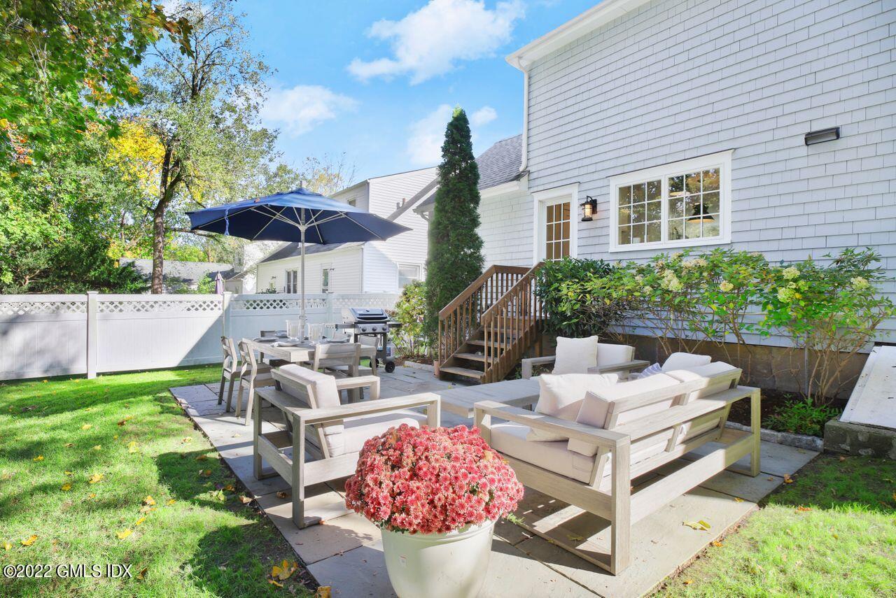 6 Ernel Drive Riverside, CT 06878 - Photo 22 of 26 a view of a patio with couches table and chairs under an umbrella