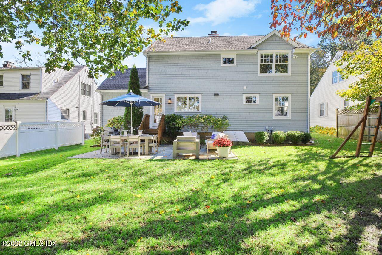 6 Ernel Drive Riverside, CT 06878 - Photo 23 of 26 a backyard of a house with table and chairs