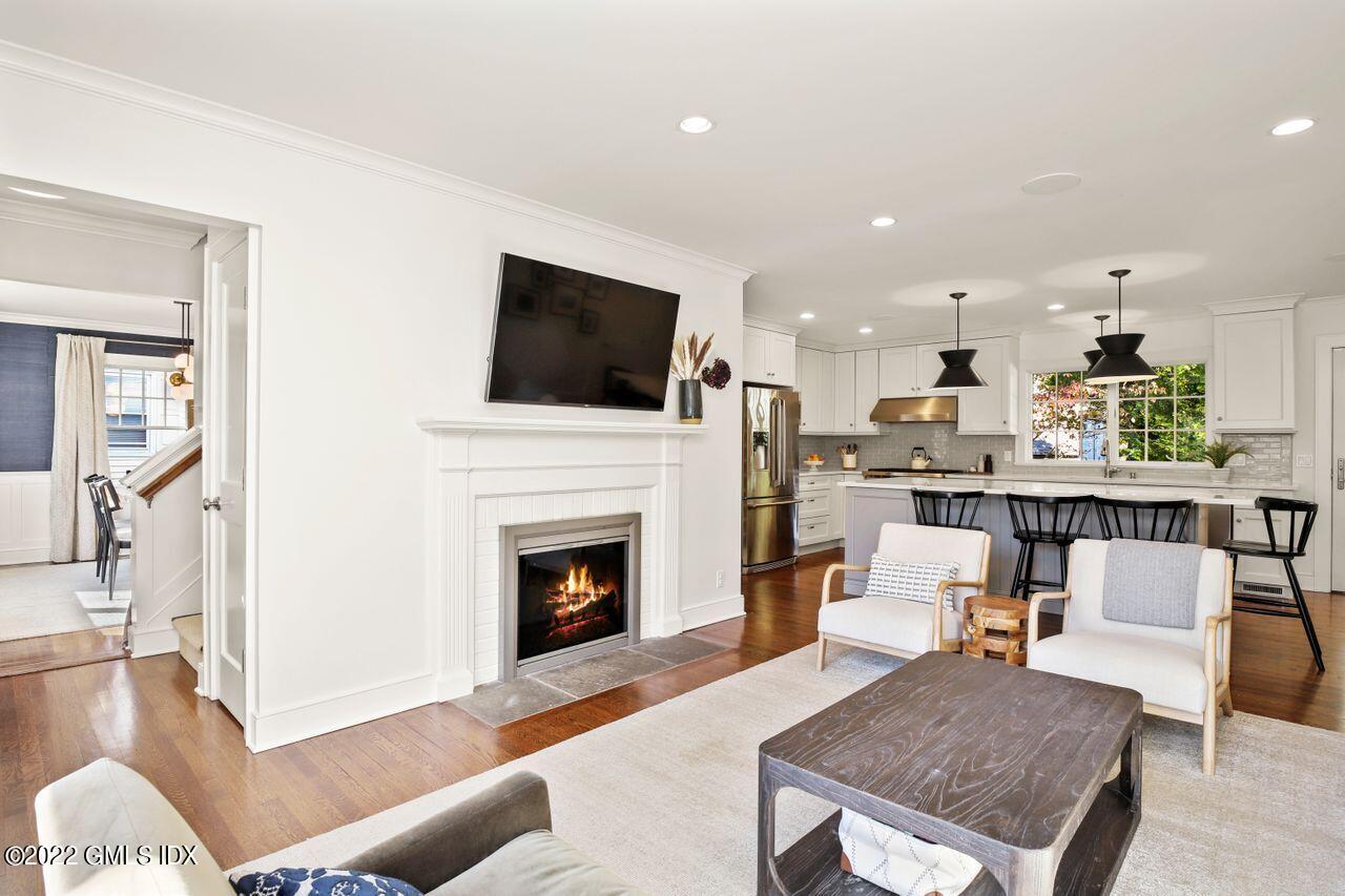 6 Ernel Drive Riverside, CT 06878 - Photo 4 of 26 a living room with furniture a fireplace and a flat screen tv