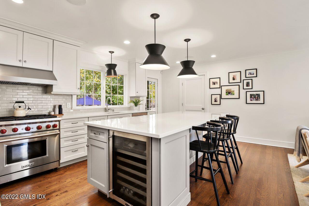 6 Ernel Drive Riverside, CT 06878 - Photo 6 of 26 a kitchen with stainless steel appliances a stove a table and chairs