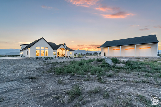 1952 Highway 118 Monroe, UT 84754 - Photo 69 of 88 Back of house with a garage, an outbuilding, and stucco siding